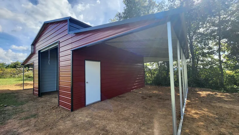 Rustic red Apex barn with a boxed-eave roof, roll-up door and open lean-to
