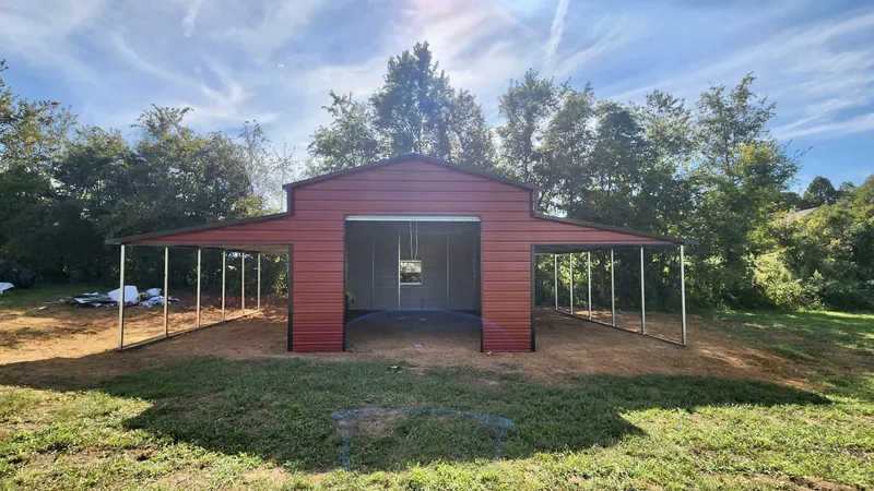Rustic red boxed-eave Apex barn with open lean-tos on both sides