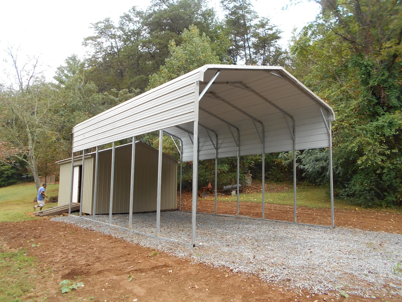 White regular-roof carport on a gravel pad