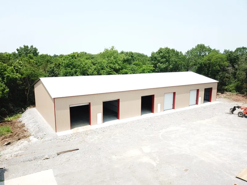 Aerial view of a finished light stone commercial building with multiple roll-up doors