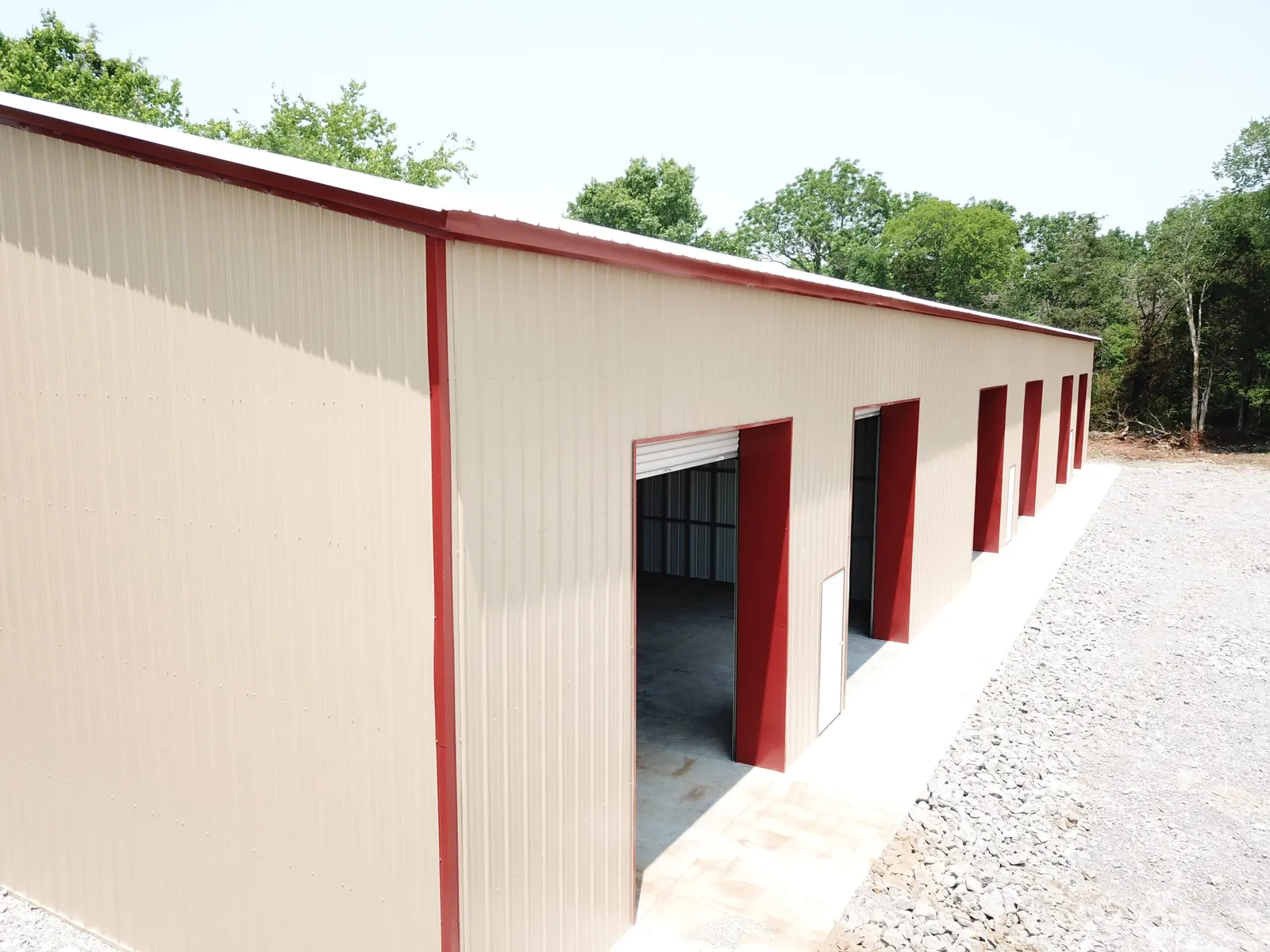 Light stone commercial building with a row of roll-up doors