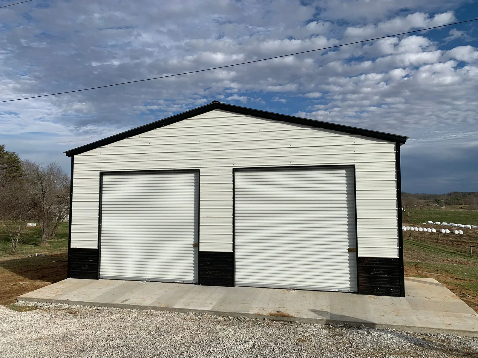 White two-door garage with black wainscot