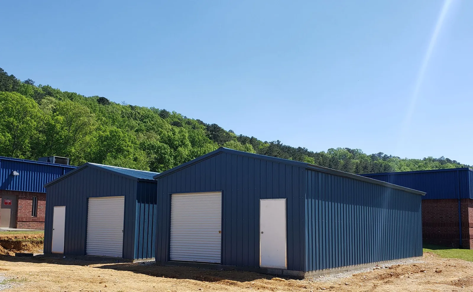 Two blue vertical-roof workshops