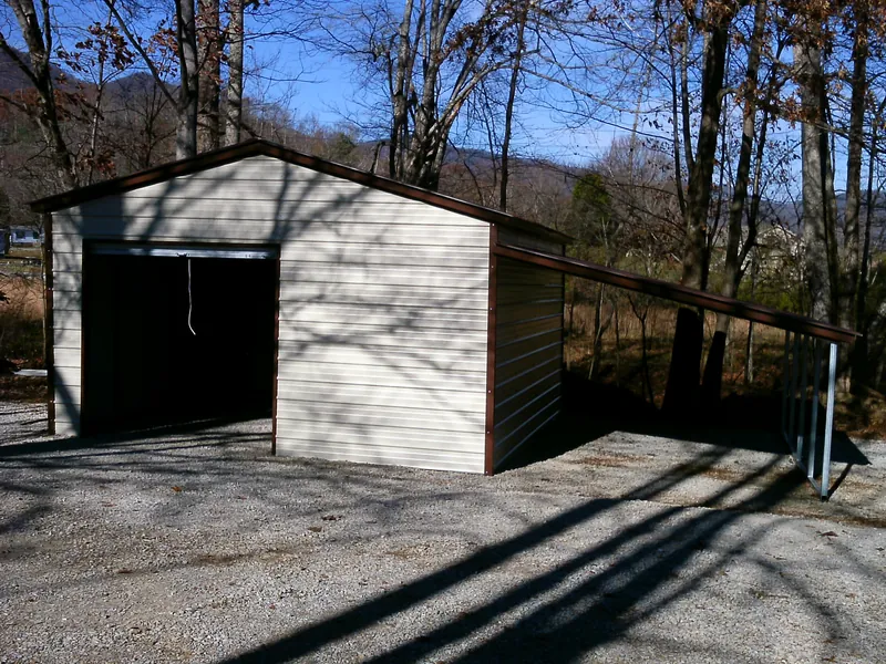 Light stone and brown boxed-eave workshop with an open lean-to on gravel